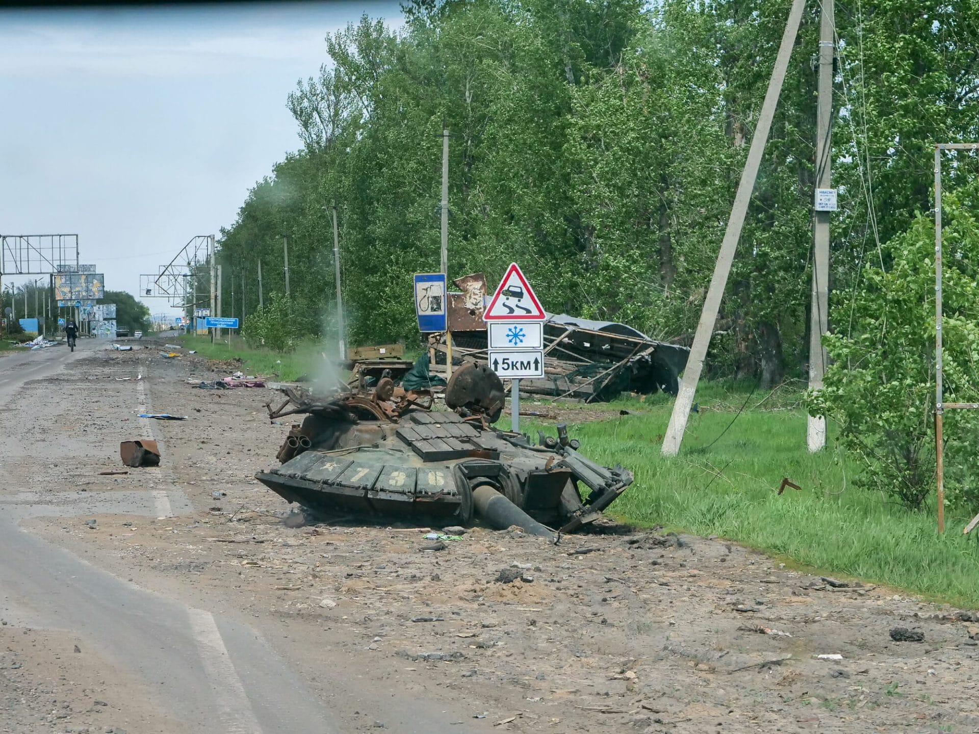 A destroyed tank stands on the side of the road in Kharkiv.