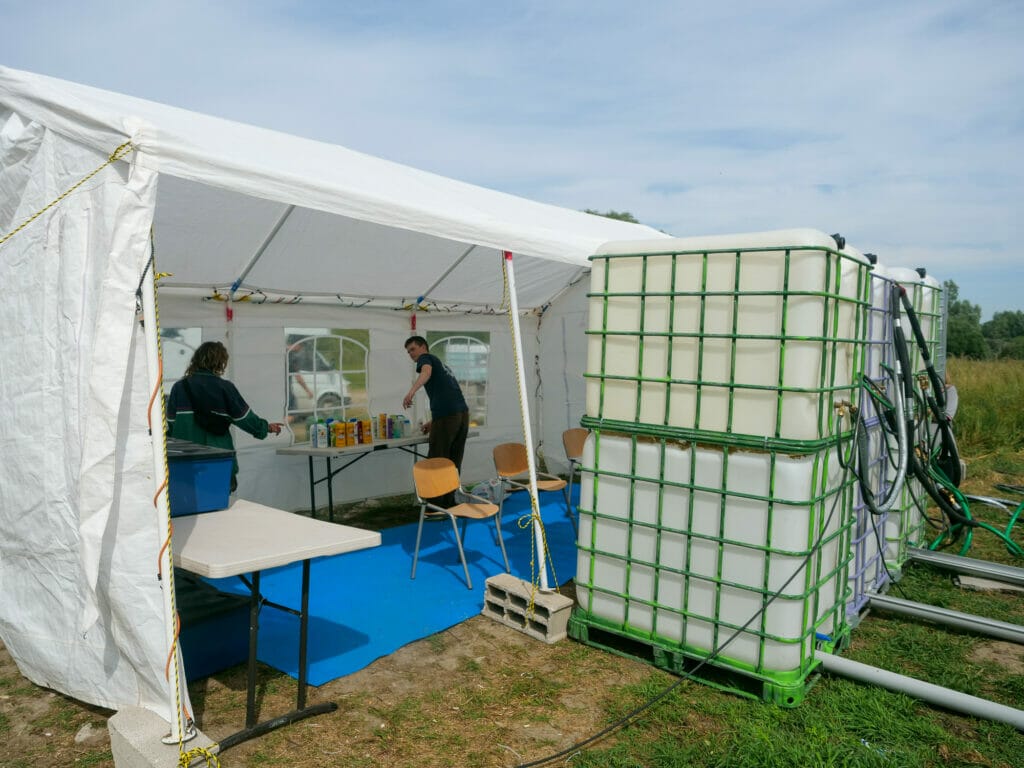 Freiwillige von Mobile Refugee Support (MRS) bauen mobile Duschen auf und bieten Handy-Ladestationen an.