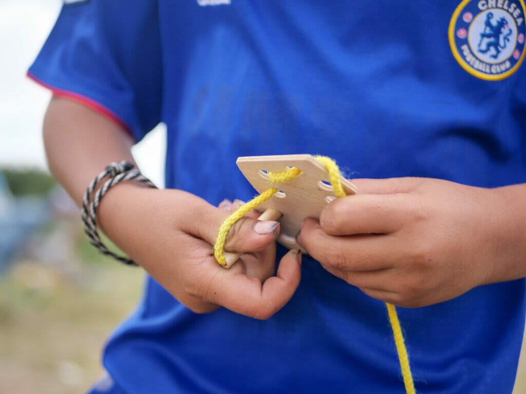 Mehrere Hundert Menschen warten in einem selbst errichteten Camp auf die Überfahrt nach Großbritannien. Rahmi und Lana haben ein paar Spielzeuge für die Kinder besorgt.