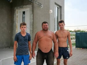The house of Sergey Stepevoy (40), here with his sons Kyrill (14, left) and Nikita (17, right) and his nine greenhouses were severely damaged.