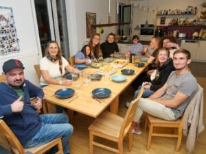 Die Münchner Inklusions-WG versammelt sich an einem Tisch.